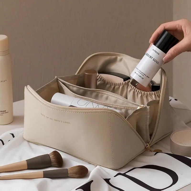 a person holding a bottle of makeup in a bag