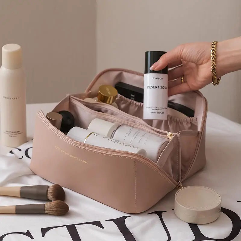 a person is holding a bag full of beauty products